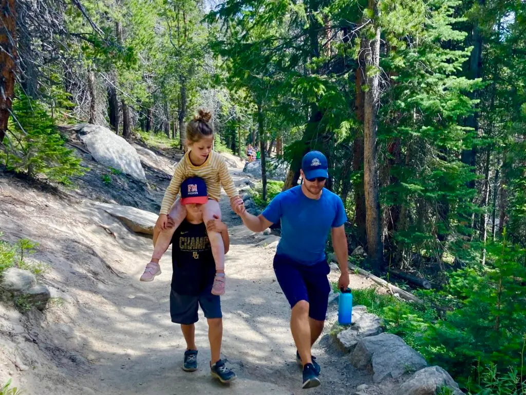 Family hiking an easy trail during a soft adventure trip to Estes Park Co